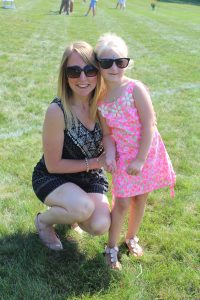 woman and little girl in sunglasses pose for camera