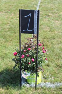 field one sign with flowers at 4th annual croquet on the green