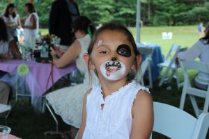 little girl with Dalmatian face paint at 4th annual croquet on the green