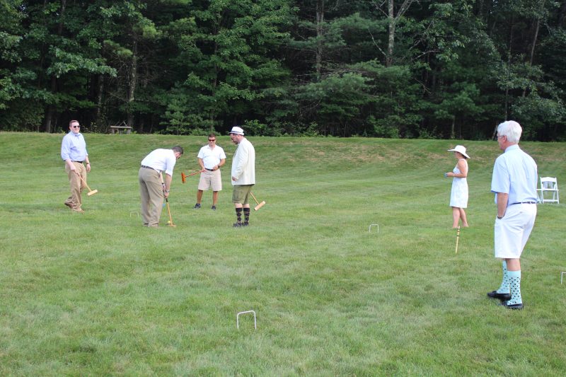 Group of Croquet on the Green players on grass