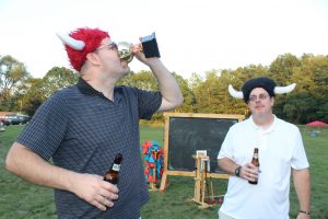 viking croquet guys celebrating the day drinking beers out of trophy cup