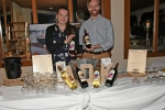 Stephanie Willis, Ethan Collins presenting bottles of Adirondack Winery Wine at the Vin Le Soir event