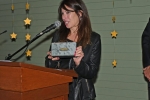 Artist Debbie Brooks presenting a power of potential clutch for AIM Services