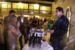 Woman tasting wine at the Specialty Wines & More vendor table at the Vin Le Soir event