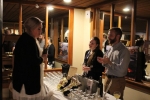 Staff from Adirondack Winery describing wine to a woman at the Vin Le Soir event