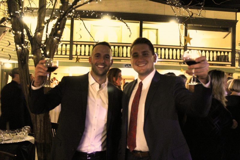 Ryan Duff, Dan O'Keefe with raised wine glasses at the Vin Le Soir event
