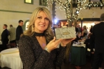 Lynn Corbitt presenting a clutch engraved with "power of potential" designed by Debbie Brooks