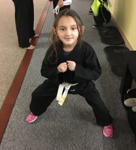 Julianna in martial arts wear with white belt