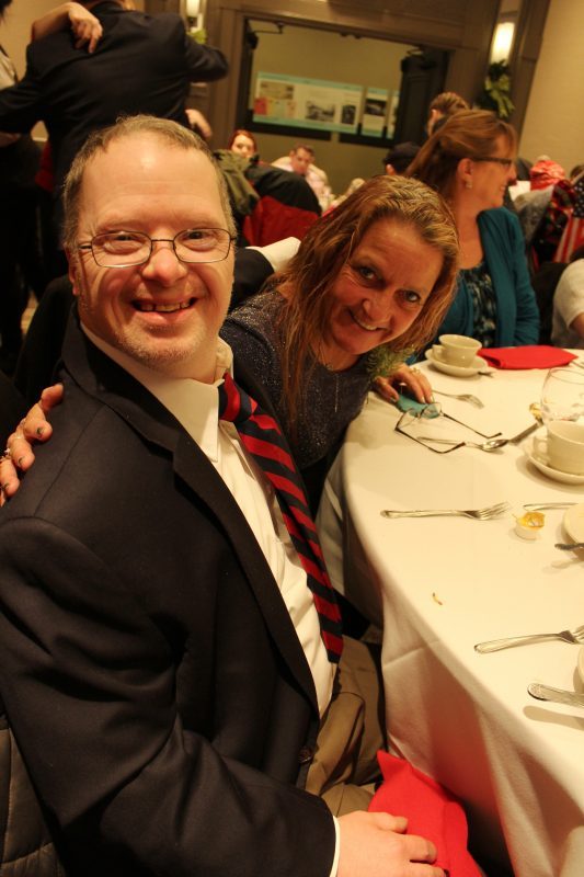 Man and woman sitting at a table at the Holiday Tea event
