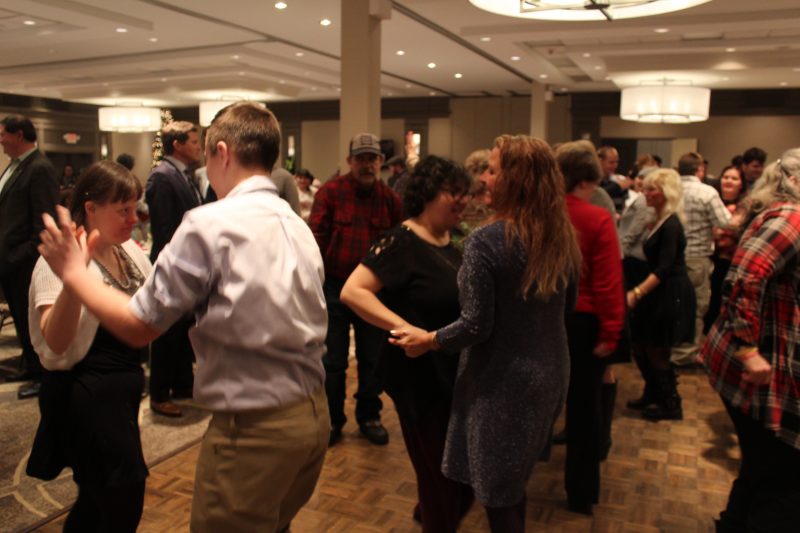 People dancing at the Holiday Tea event