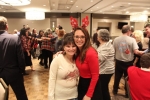 Two woman smiling on the dance floor at the Holiday Tea party