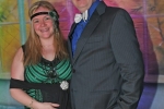 Woman dressed as a flapper with a man with a white bowtie smiling at Mardi Gras for AIM Services