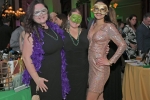 Three women in masks smiling at Mardi Gras for AIM Services