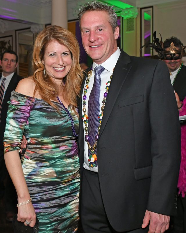 Couple smiling at Mardi Gras for AIM Services