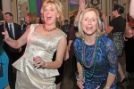 Two woman dancing at Mardi Gras for AIM Services