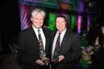 Two men with festive Mardi Gras themed ties at Mardi Gras for AIM Services