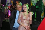 Two people smiling on dance floor at Mardi Gras event for AIM Services