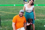 Couple with chocolate lab at the Saratoga Dog & Pony Show to benefit AIM Services, Inc.