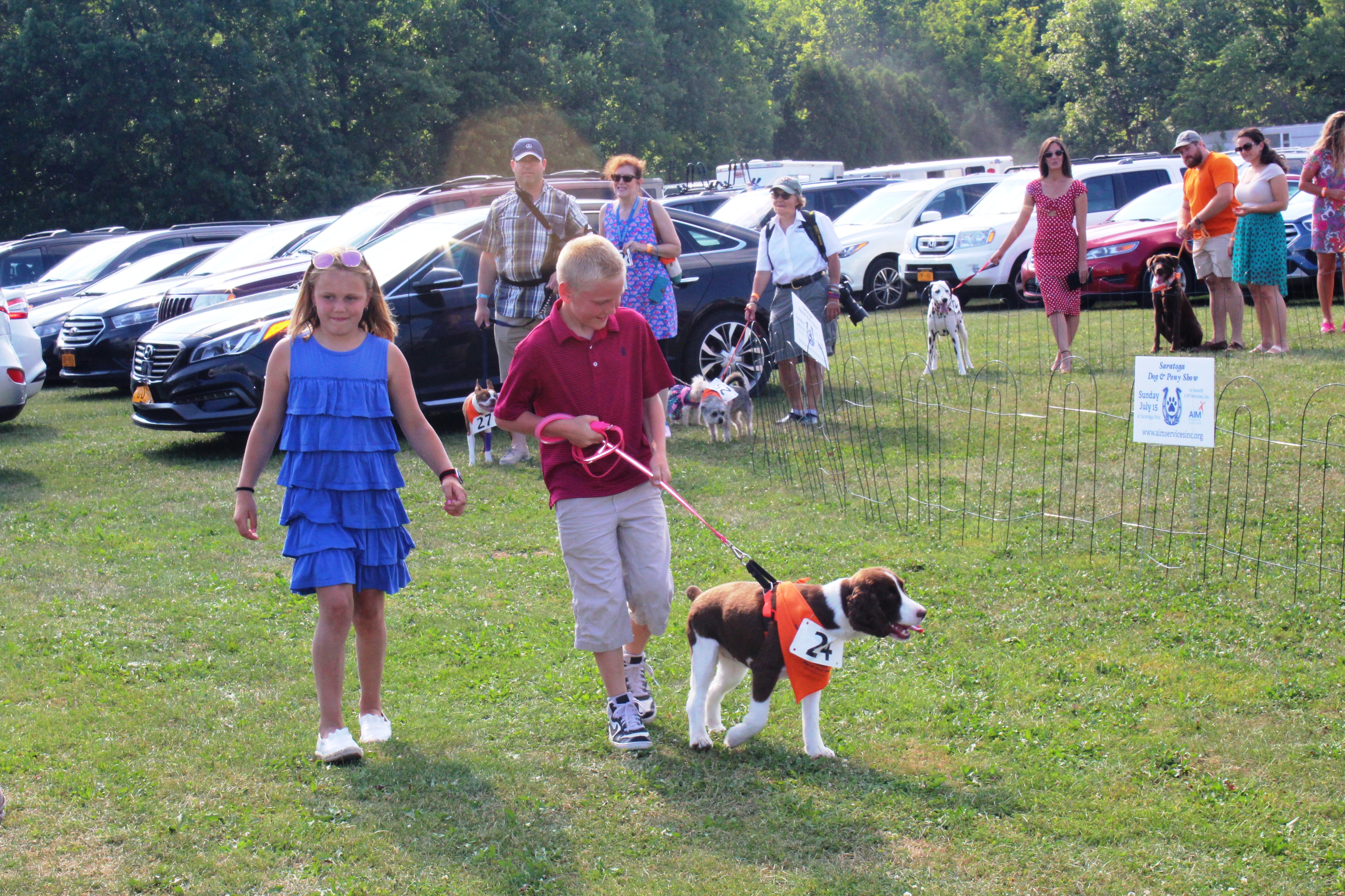 Two kids walking dog at the Saratoga Dog & Pony Show to benefit AIM Services, Inc.