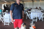 Man smiling with two dogs at the Saratoga Dog & Pony Show to benefit AIM Services, Inc.