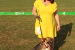 Woman in yellow dress with beagle mix dog at the Saratoga Dog & Pony Show to benefit AIM Services, Inc.
