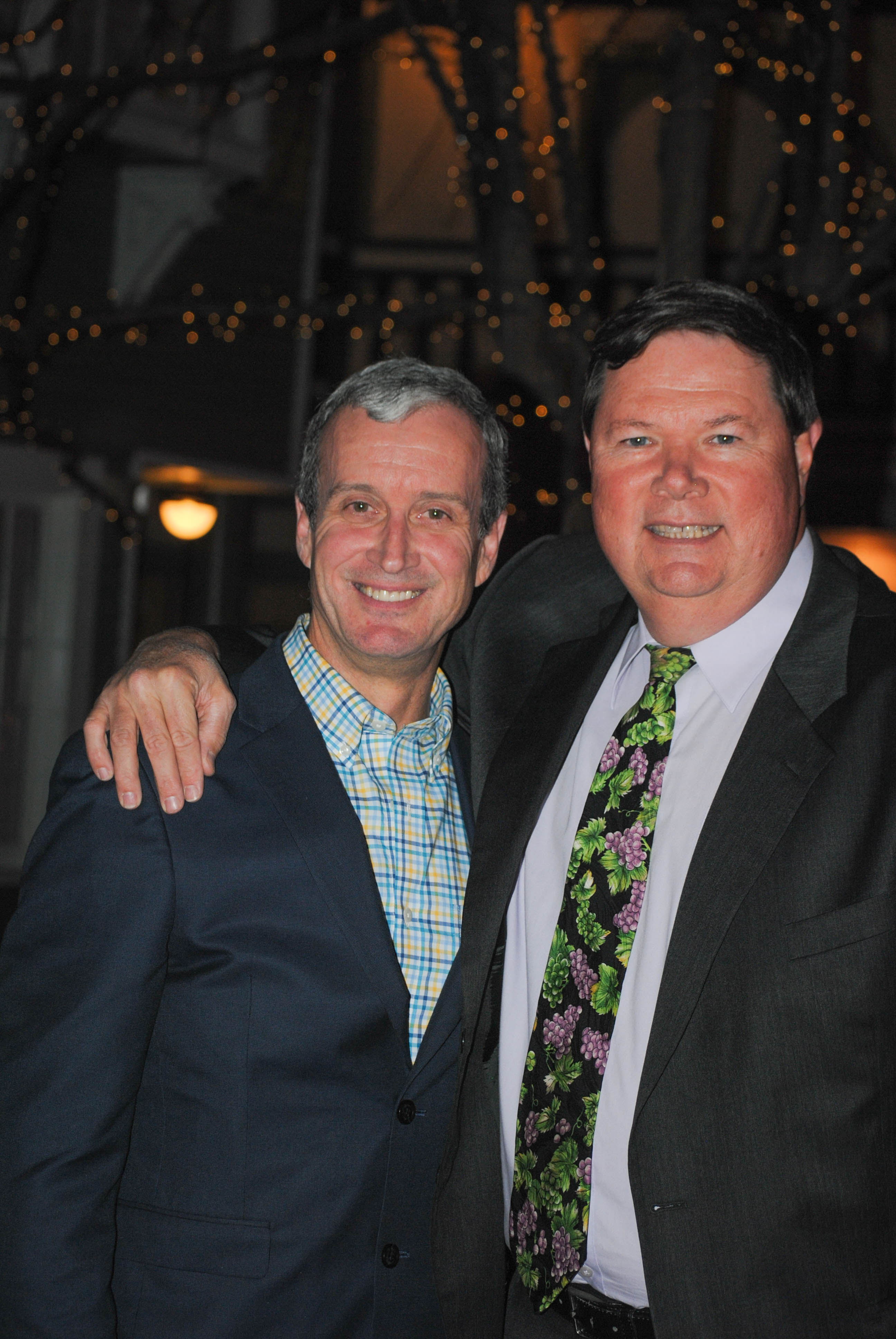 Two men smile for photo at Vin Le Soir to benefit AIM Services, Inc.