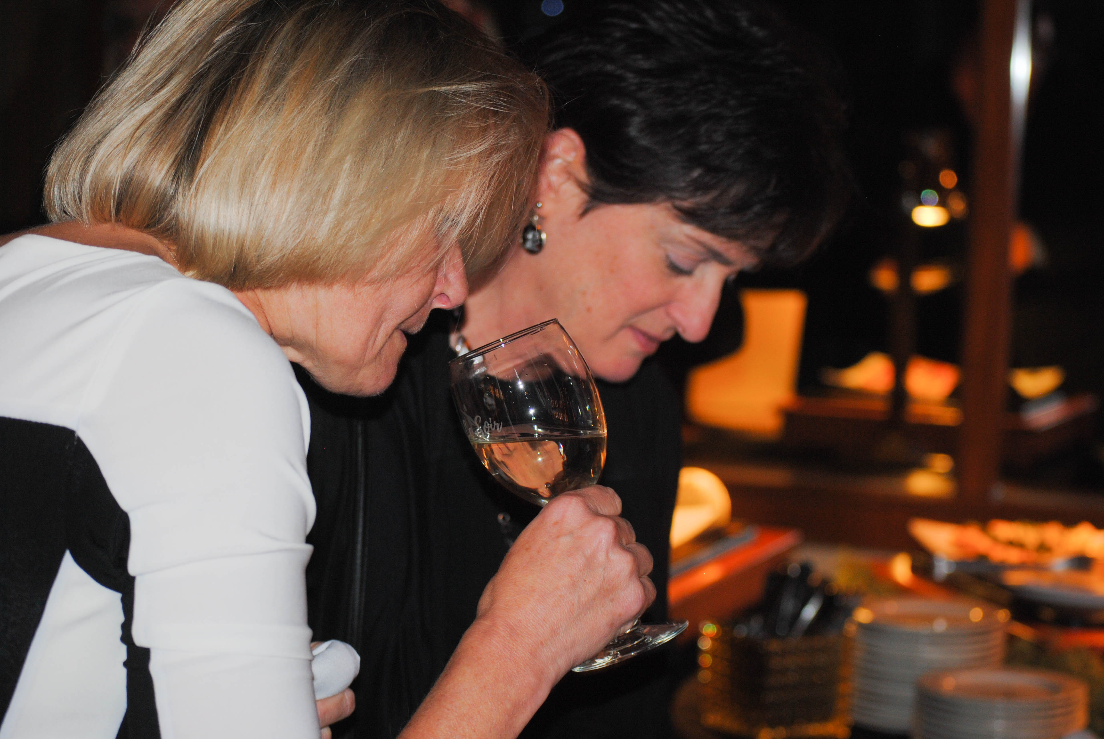 Vin Le Soir to benefit AIM Services, Inc. woman tasting wine