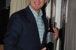 Vin Le Soir to benefit AIM Services, Inc. man holding bottle of wine