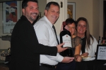 Vin Le Soir to benefit AIM Services, Inc. group of people holding a huge bottle of wine