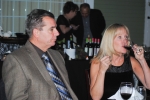 Vin Le Soir to benefit AIM Services, Inc. two people at table, one drinking wine