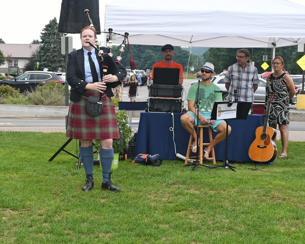 Woman playing bagpipes at AIM Services Croquet on the Green event