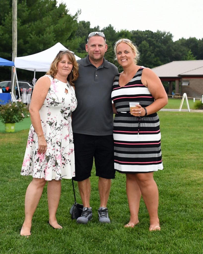 Group of three people at AIM Services Croquet on the Green event