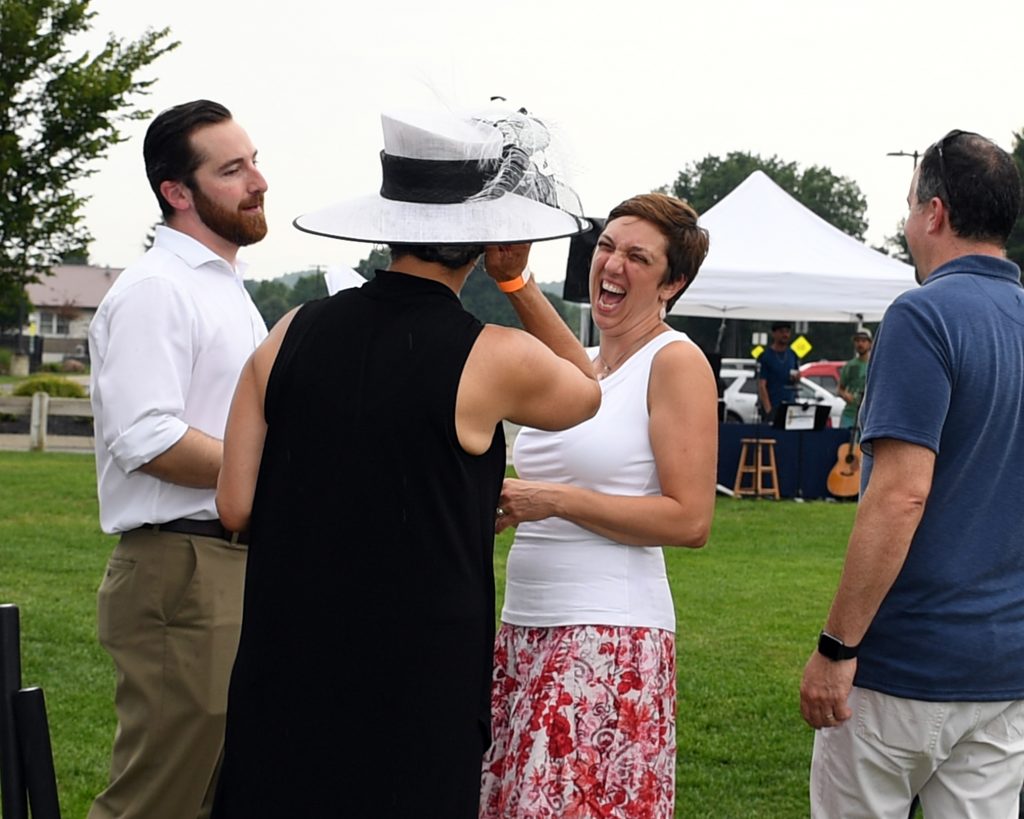 Group of people talking and laughing at AIM Services Croquet on the Green event