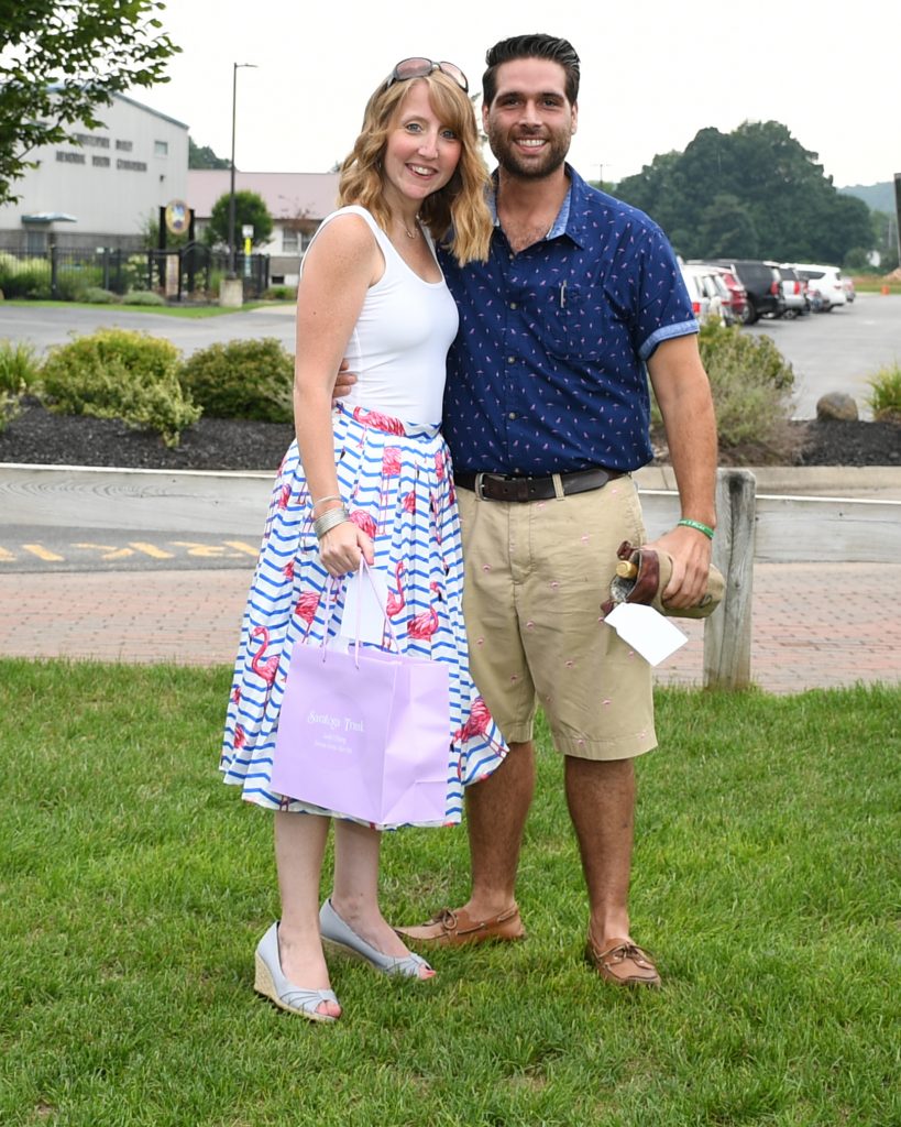 Couple in flamingo themed clothing with winning best dressed prizes at AIM Services Croquet on the Green event