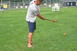 Man taking swing with mallet at AIM Services Croquet on the Green event