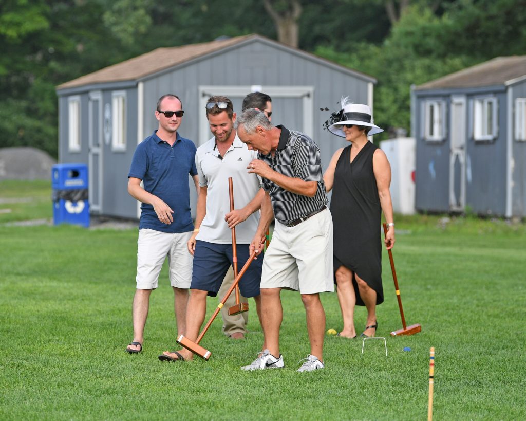 Group of players walking off the field at AIM Services Croquet on the Green event