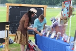 Two people looking at raffle tickets at AIM Services Croquet on the Green event