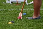 Close up of a mallet hitting a ball at a wicket at Croquet on the Green 2019