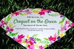 Croquet on the Green fan with flowers on the edges in the grass at Croquet on the Green 2019