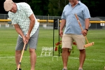 Man hitting croquet ball as another man looks on at Croquet on the Green 2019
