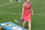 Woman throwing bag at cornhole at Croquet on the Green 2019