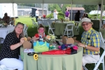 Couple with granddaughter at table at Croquet on the Green 2019