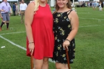 Girl in red dress and girl in black dress with flowers posing with croquet mallets at Croquet on the Green 2019