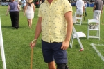 Man in yellow shirt and cigar in mouth smiling at Croquet on the Green 2019
