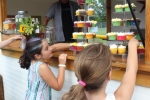 Two young girls looking at cupcakes at Croquet on the Green 2019