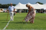 Woman hitting croquet ball with man looking on at Croquet on the Green 2019