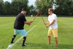 Two men holding croquet mallets up like swords at Croquet on the Green 2019