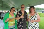 Three women holding glasses of champagne at Croquet on the Green 2019