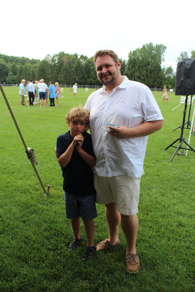 Father and young son smiling together at Croquet on the Green 2019
