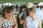 Woman showing two other woman her bracelet at Croquet on the Green 2019
